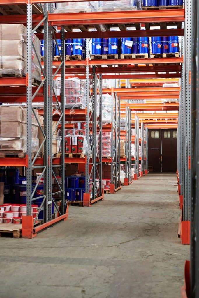 pexels photo 4483609 Industrial warehouse interior with organized shelves stacked with packages and goods.